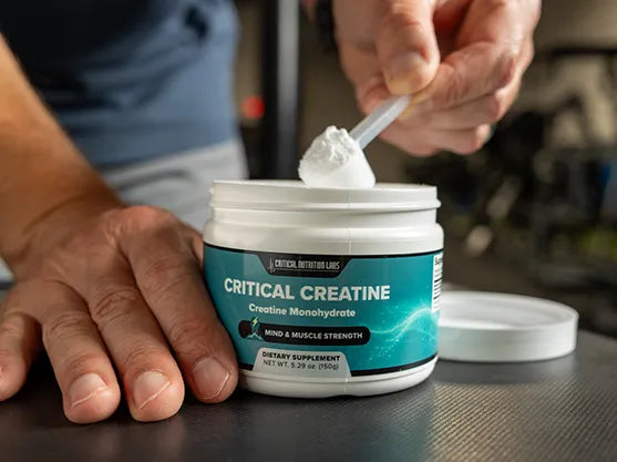 Scooping Critical Creatine powder from the jar